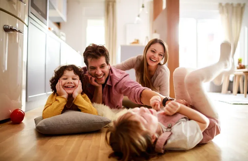 family laughing and playing in pest free home