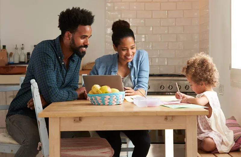 Family mother and father helping daughter with homework in pest free home