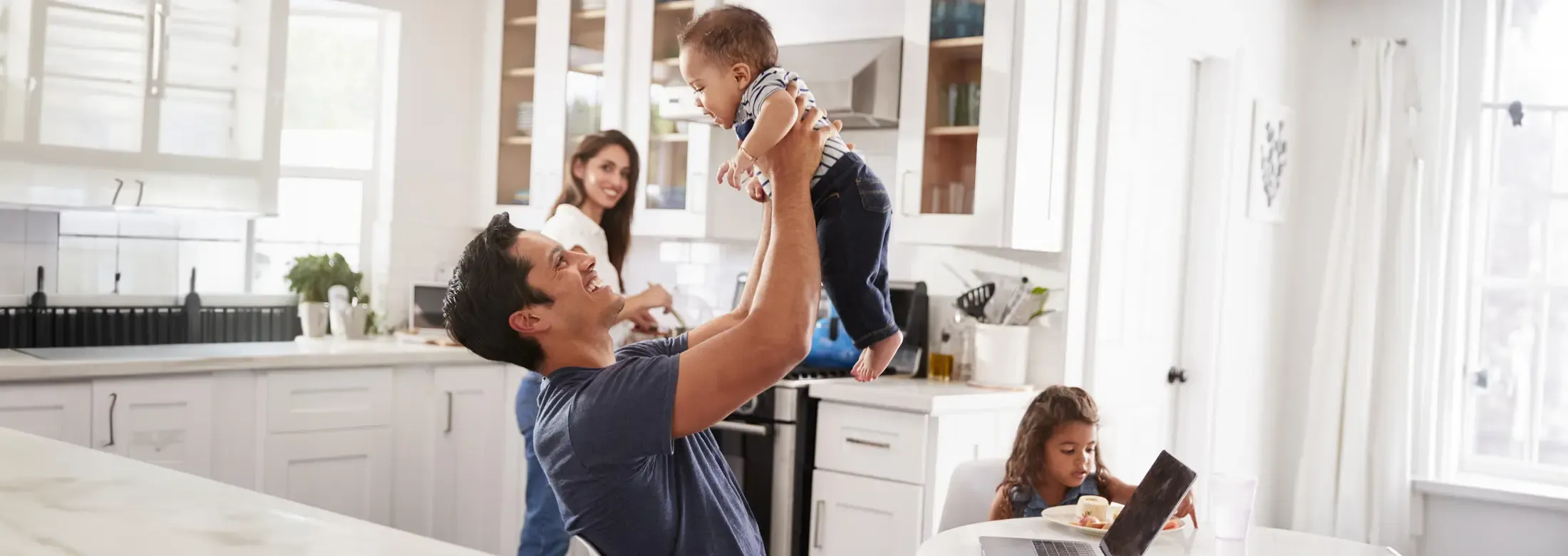 dad playing with son in pest free kitchen