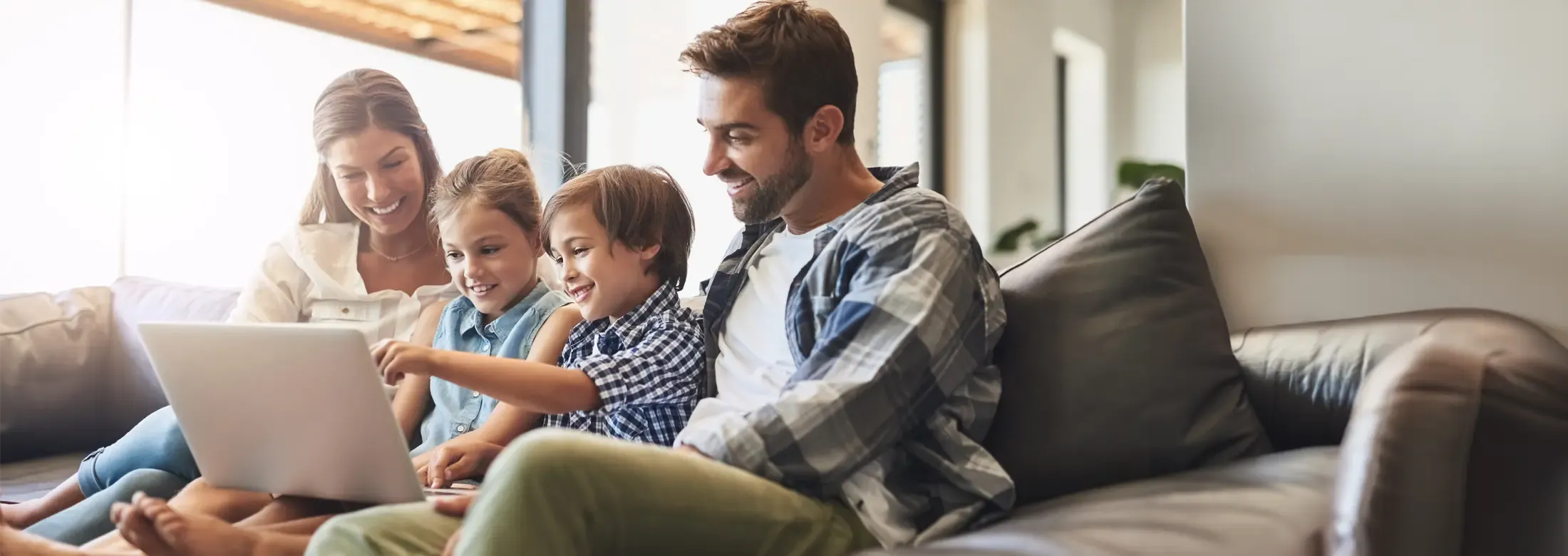 family playing on computer in pest free home